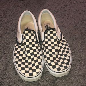 Checkered slip on vans.